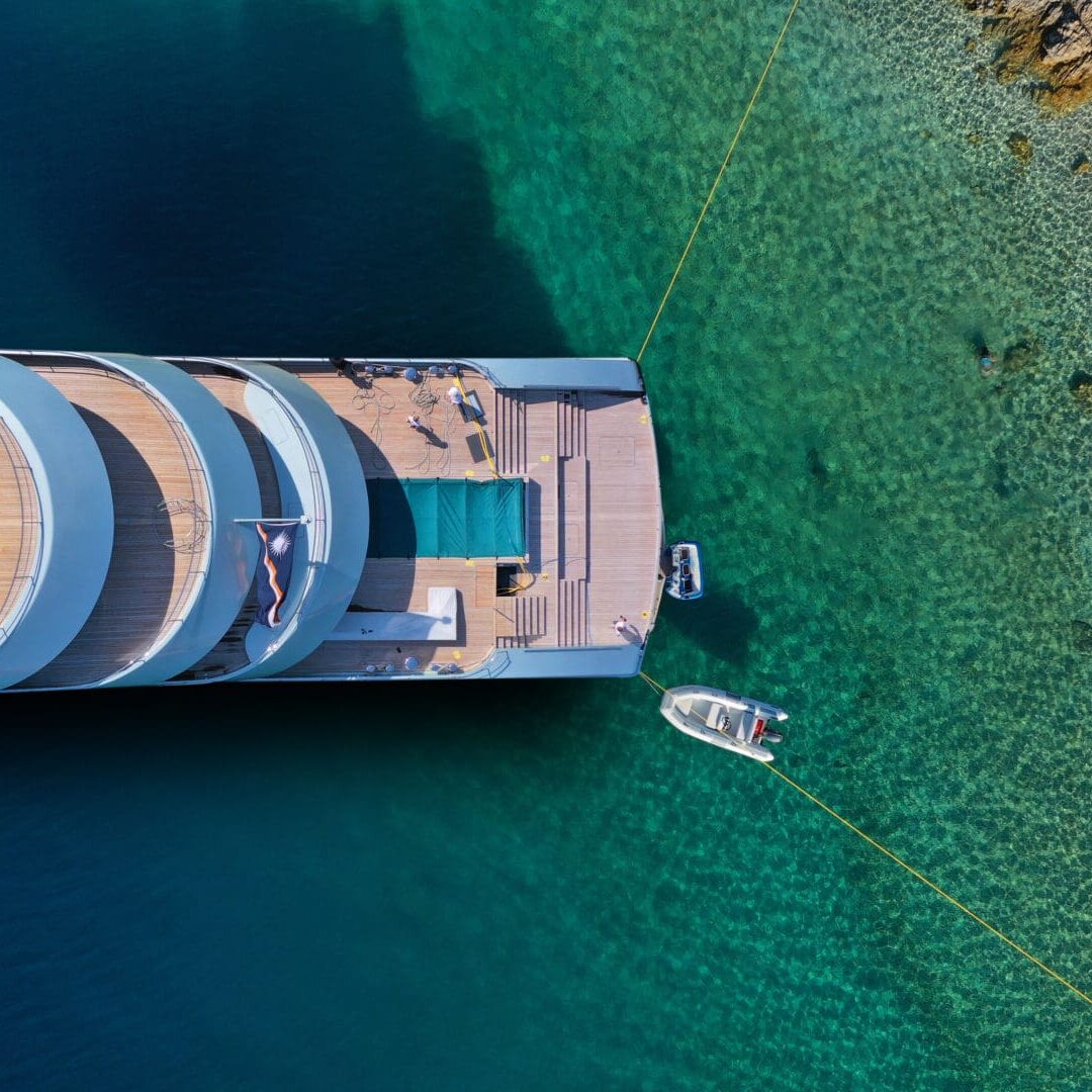 Superyacht Med-Moored with rock lines securing the bow to shore, representing TenderTow™ Med-Moor and mooring line solutions.